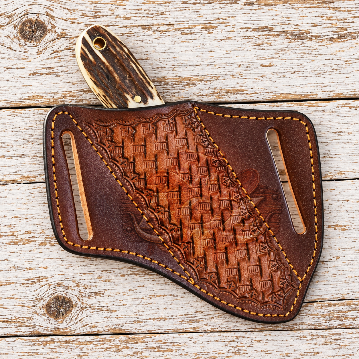 A hand-tooled brown leather knife sheath with a carved wooden handle, displayed on a rustic white-washed wooden plank background.