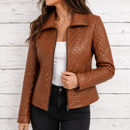 A woman wearing a brown quilted faux-leather moto jacket with an asymmetrical zipper and snap collar, styled over a white top and black jeans 