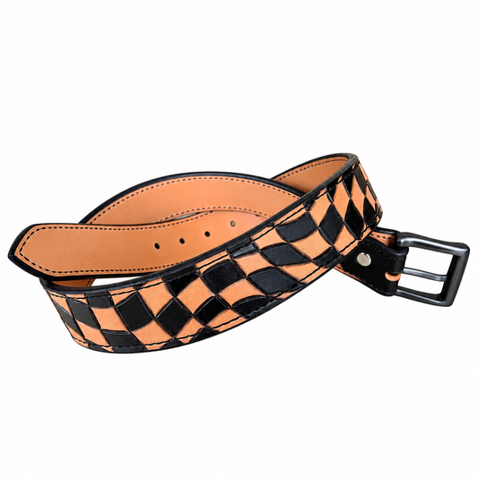 A woven leather belt with a black and tan checkerboard pattern, featuring a black metal buckle and a black tip, displayed on a clean white background.
