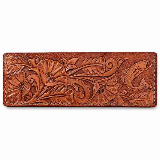 A bifold brown leather wallet featuring hand-tooled floral and fish motifs on a plain white background.