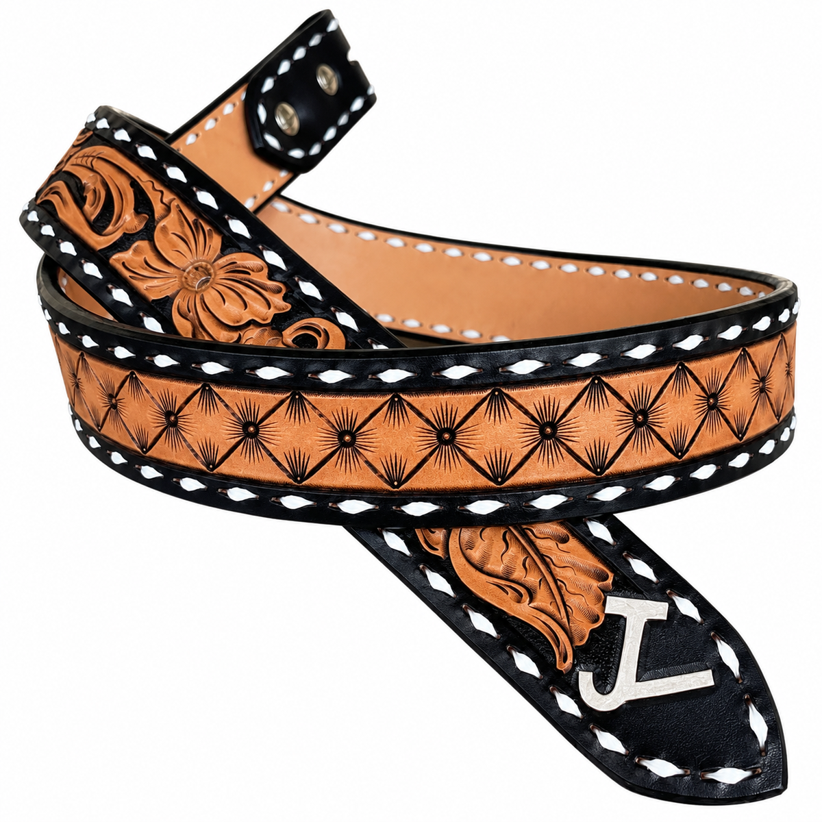 A tooled leather belt with a warm tan/caramel base, black floral and geometric tooling, white contrast stitching, and a silver buckle, shown on a plain white background.
