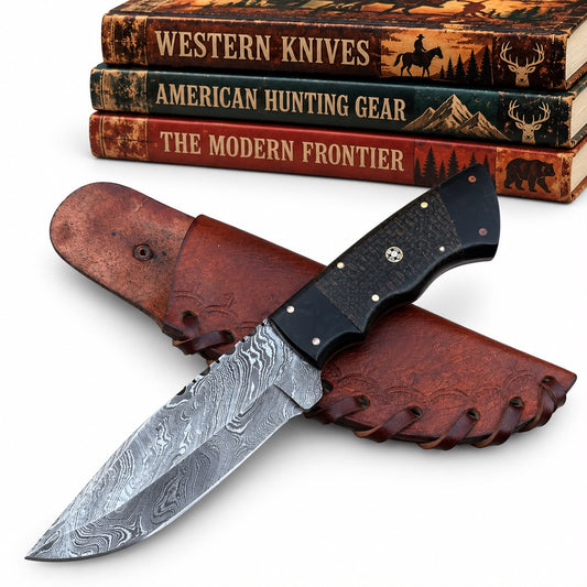 A fixed-blade knife with a patterned steel blade and black handle is displayed on a brown leather sheath, with three decorative books in the background reading 'Western Knives,' 'American Hunting Gear,' and 'The Modern Frontier.'.