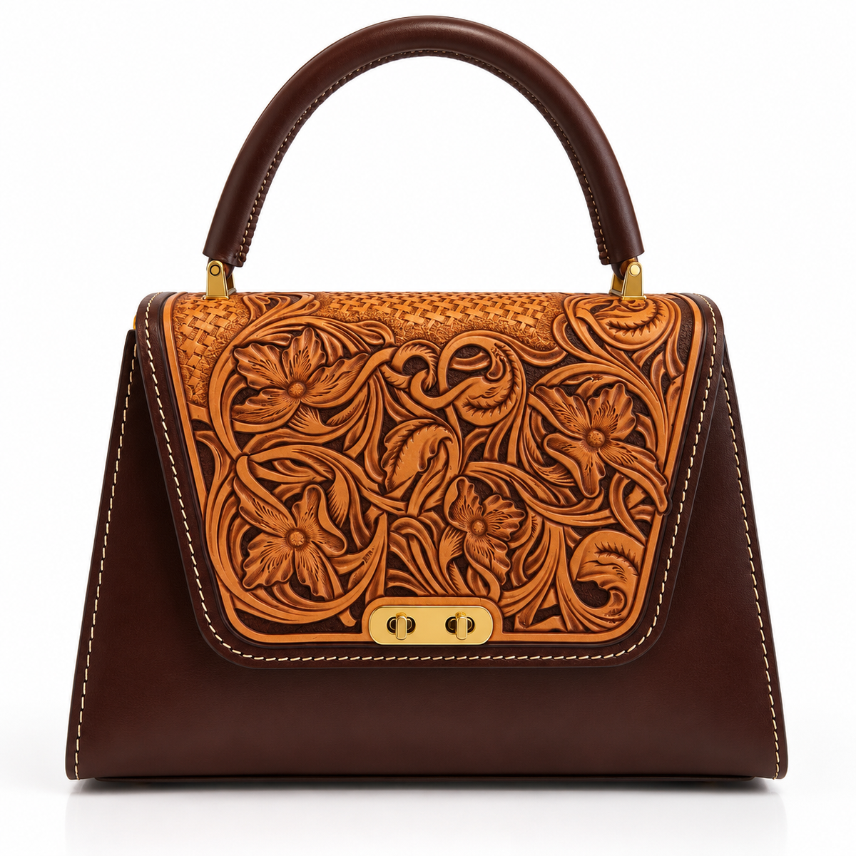 A structured dark brown leather handbag with an intricate floral tooled leather panel on the front flap, featuring gold-tone hardware and a top handle, set against a plain white background.