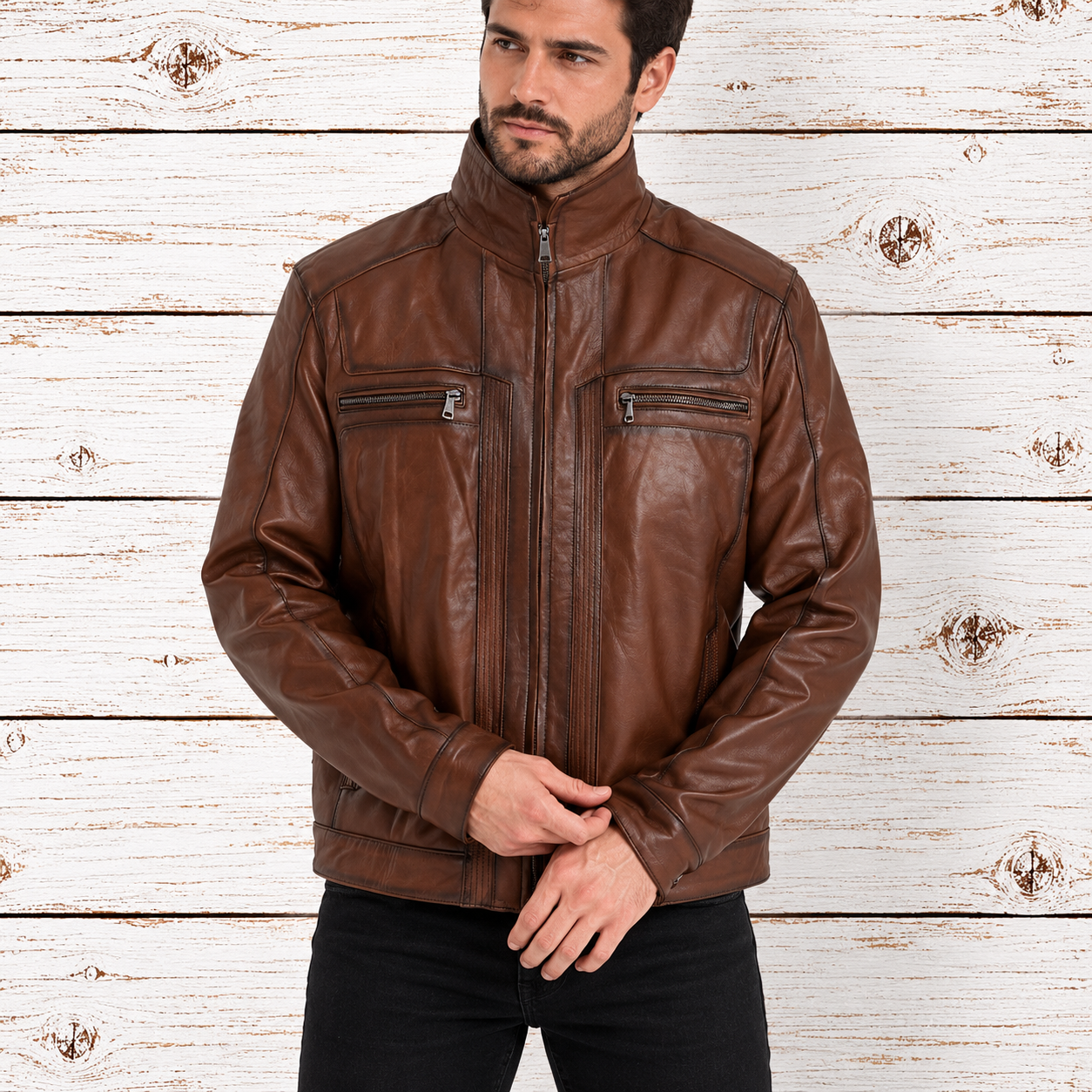 A man wearing a brown leather jacket with a high collar, front zipper, and zippered chest pockets