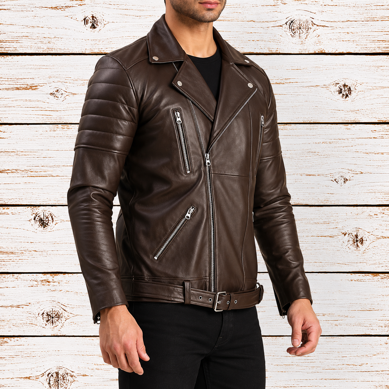 A man wearing a dark brown leather motorcycle jacket with silver zippers, paired with a black shirt and black pants