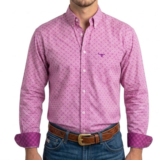A man wearing a pink long-sleeve button-down shirt with a small geometric pattern, rolled-up sleeves showing a purple check lining, and blue jeans with a brown leather belt.