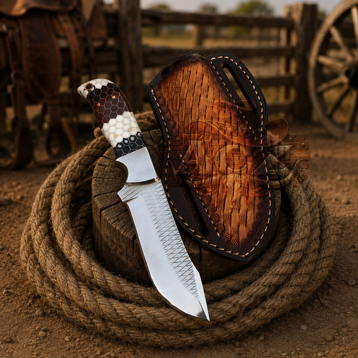 A fixed-blade knife with a patterned handle and a textured silver blade rests on a coiled rope next to a carved wooden sheath, set against a rustic outdoor background with a wagon wheel and fence.
