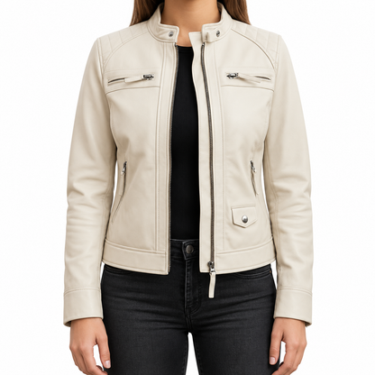 A woman wearing a light cream faux leather motorcycle jacket with silver zippers and snap details, layered over a black top and black jeans, shown against a plain white background.