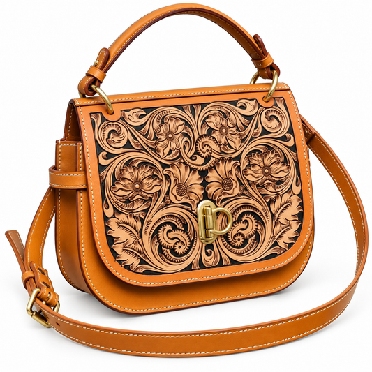 A tan leather handbag with an intricate floral tooled design on the front flap, featuring a gold-tone turn-lock clasp and a matching top handle, set against a plain white background.