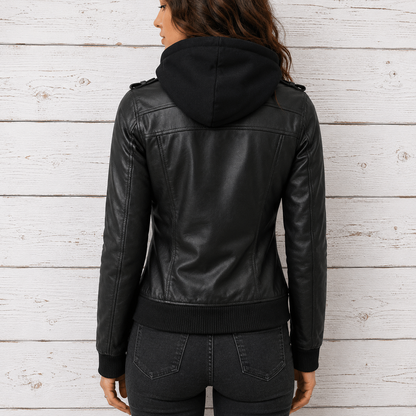 A woman viewed from the back wearing a black leather hooded jacket with ribbed hem and cuffs, paired with dark gray jeans