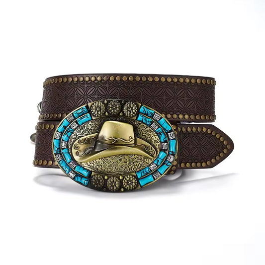 A brown embossed leather belt with a large western-style buckle featuring a gold hat motif, turquoise blue stones, and brass studs, shown on a white background.