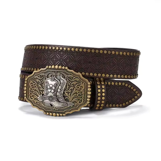 A dark brown tooled leather belt with a large western buckle. The belt features embossed floral patterns, gold-toned studs, and a prominent decorative buckle with a silver-toned cowboy boot motif and gold-toned border.
