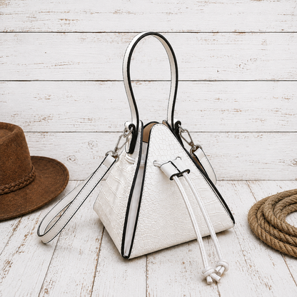 A white textured bucket-style handbag with black trim and a top handle, styled 